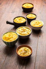 Shrikhand & Amrakhand served in different size bowl in group. Selective focus