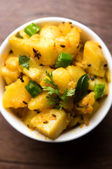Chatpate Masala Aloo Sabzi fry OR Bombay potatoes served in a bowl, selective focus