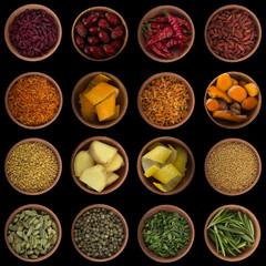 set of spices in wooden cups  isolated on black background. top view