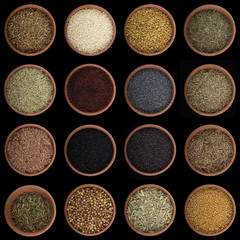 set of spices in wooden cups isolated black background. top view