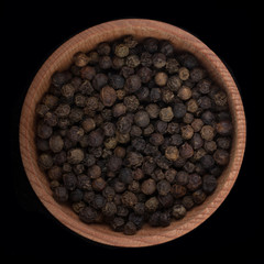 black peppercorn isolated on black. top view