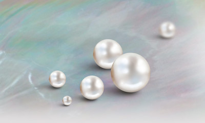 White pearls on turquoise and mauve mother of pearl background