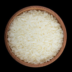 ground cococnut in wooden cup isolated on black. top view