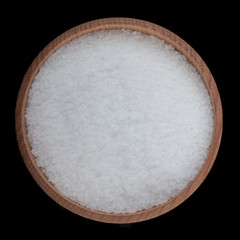 salt in wooden cup isolated on black. top view