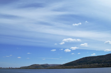 Bright blue sky with Cumulus and stratified clouds