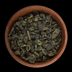 green tea in wooden cup isolated on black. top view