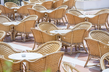 Table and rattan chairs in beach cafe next to the red sea in Sharm el Sheikh, Egypt