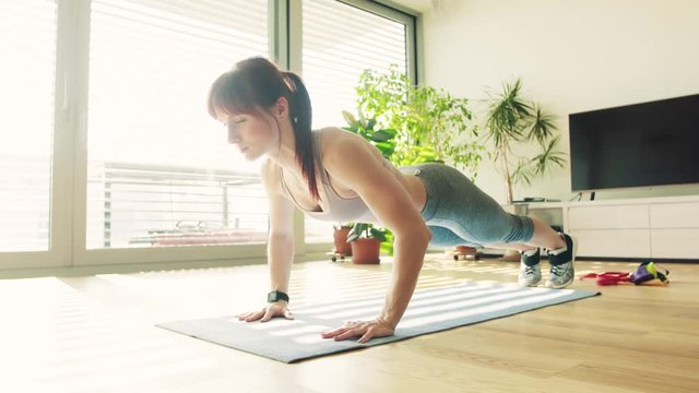 Young fitness woman doing exercise at home.