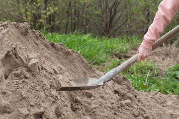 girl digging sand shovel