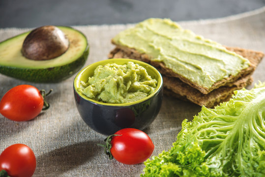 Mexican cold appetizer made of pureed avocado pulp with bread and vegetables. Concept healthy vegetarian Breakfast