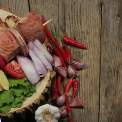 Fotobehang shashlik with vegetables on wooden background © lewal2010