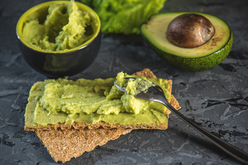 Mexican cold appetizer made of pureed avocado pulp with bread and vegetables. Concept green healthy vegetarian Breakfast