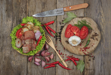 meat with vegetables on wooden background