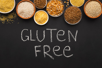 Various gluten free groats on black background with copy space