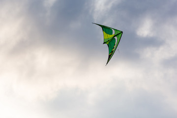 A Kite Flying Against the Dark Storm Clouds