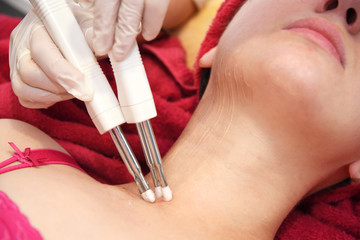 Microcurrent therapy. Hardware cosmetology. Face rejuvenation. Salon procedure.