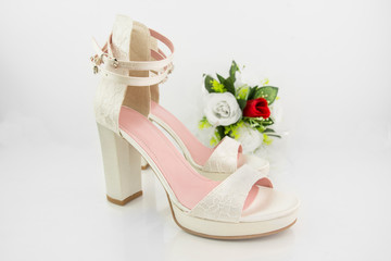 Elegant Luxury Laced Bridal Wedding Shoes And Bouquet With Red Rose On White Background Closeup