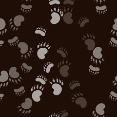 Obraz premium Footmark of the bear paw. Seamless pattern background. Brown design vector illustration.