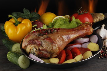 chicken with vegetables on wooden tables on fire background