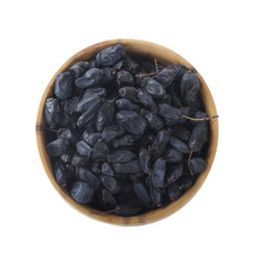 dried black barberry in wooden cup isolated on white background