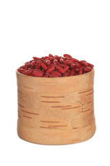 red fresh barberry in wooden cup isolated on white background