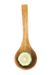 kaffir lime (bergamot)  in wooden spoon isolated on white background. top view