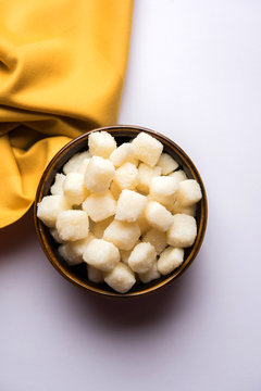 Chena Murki is indian sweet food served in ceramic bowl over moody background. selective focus