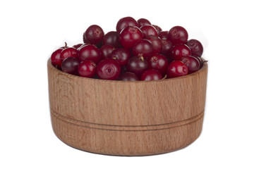 cowberry in wooden cup isolated on white background