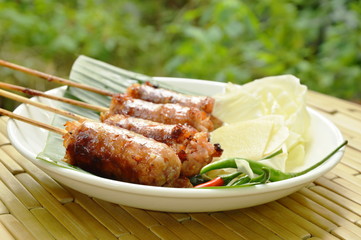 grilled Thai sausage stuffed rice and pork eat with fresh vegetable on plate
