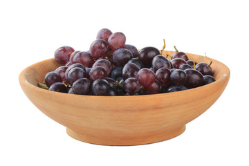 heap of red grapes in wooden cup isolated on white background