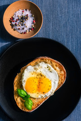 Traditional French sandwich with fried egg on a black plate