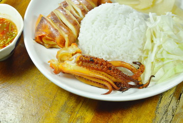 grilled squid with rice topping slice cabbage and ginger on plate