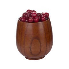 cranberries in wooden cup isolated on white background
