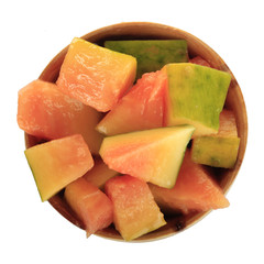 slices of pawpaw in wooden cup  isolated on white background. top view