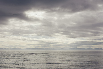 North sea with cold and snow view of the horizon and rocky coast