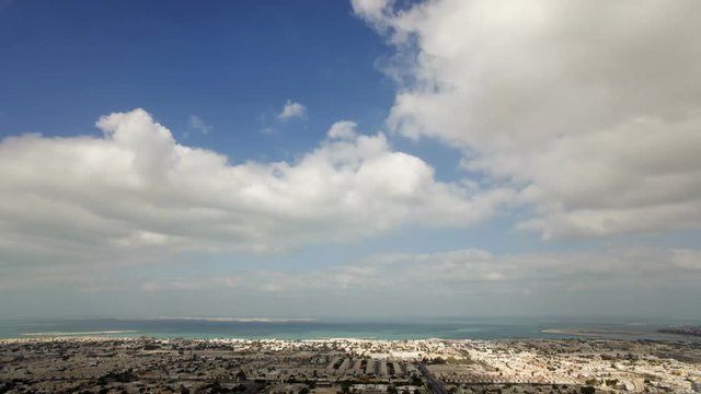 Time Lapse - High Angle Cloudscape on a beautiful day over the city of Dubai, Middle East, UAE