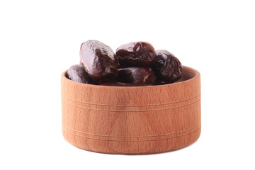 date fruits in wooden cups isolated on white background