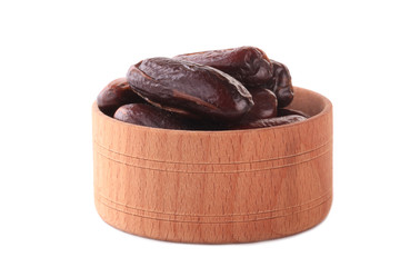 date fruits in wooden cups isolated on white background