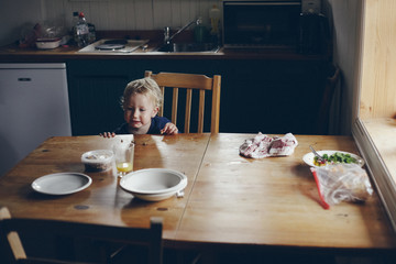 boy eating on vintage wooden table