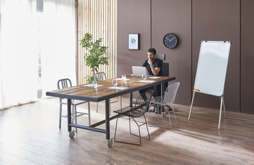 Modern meeting room decorative furniture and background. Businessman is checking about his corporation.