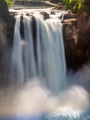 A long exposure of Snoqualmie Falls from the middle observation deck creates an image of silky water going over the falls.