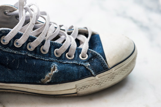 Old worn out blue sneaker