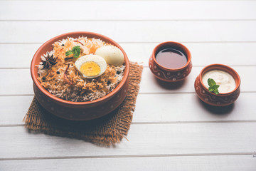 Egg Biryani - Basmati rice cooked with masala roasted eggs and spices and served with yogurt,...