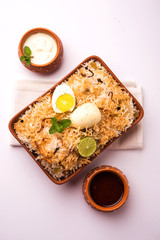 Egg Biryani - Basmati rice cooked with masala roasted eggs and spices and served with yogurt,...