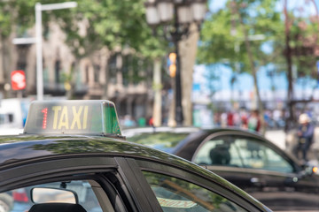 BARCELONA - MAY 11, 2018: Taxis along city roads. Barcelona attracts 10 million tourists annually