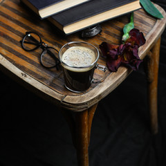 black coffee and foam in a transparent steklnny cup (portion of hot coffee)