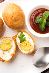 Tasty Egg Pakora or Pakoda served with tomato ketchup