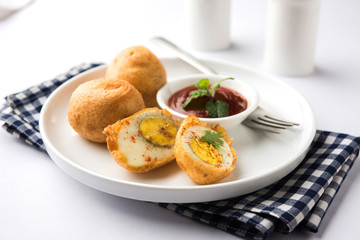 Tasty Egg Pakora or Pakoda served with tomato ketchup