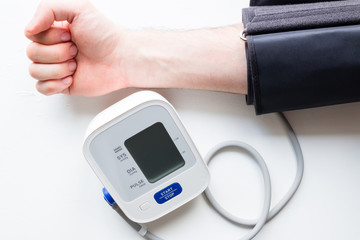 man measures his blood pressure