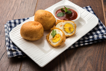 Tasty Egg Pakora or Pakoda served with tomato ketchup